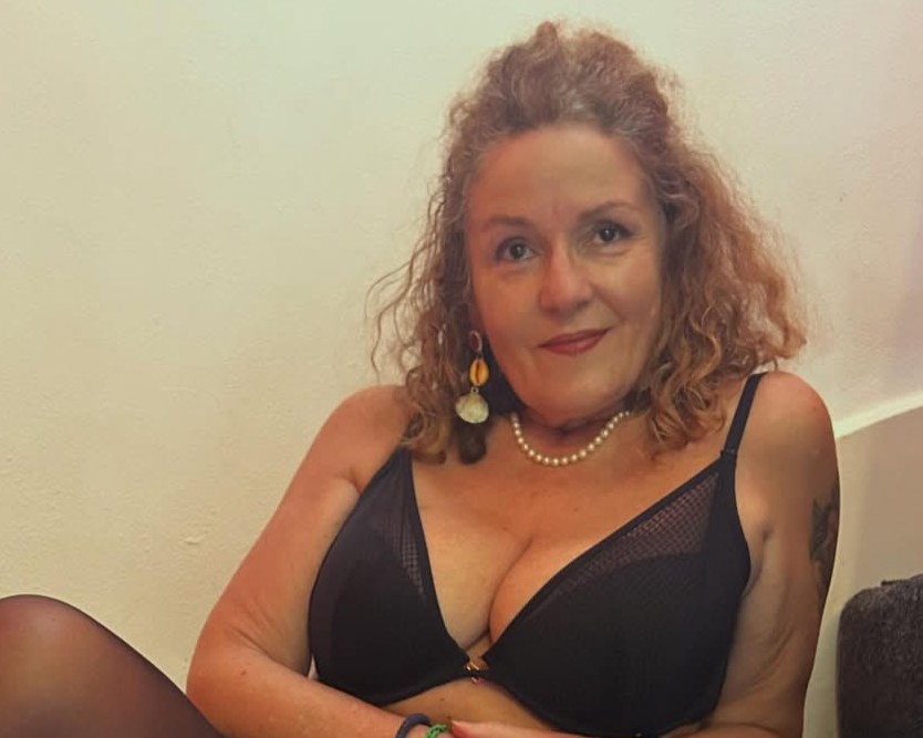 Marianna wearing nothing but a black bra