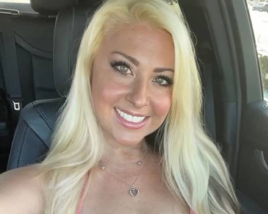 Nita Marie taking a selfie in her car wearing nothing but a bra