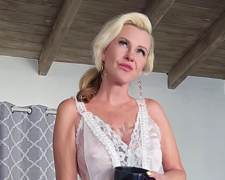 Kylie Deville in a white dress