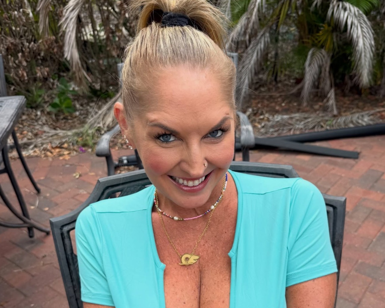 Bikini Nicole wearing a blue top with her cleavage showing